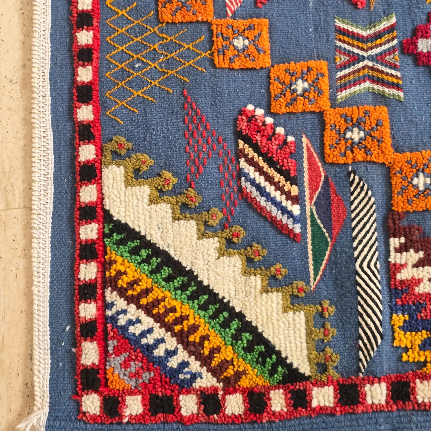 Close-up of the fringe detail on a handwoven Berber rug, featuring Moroccan weaving