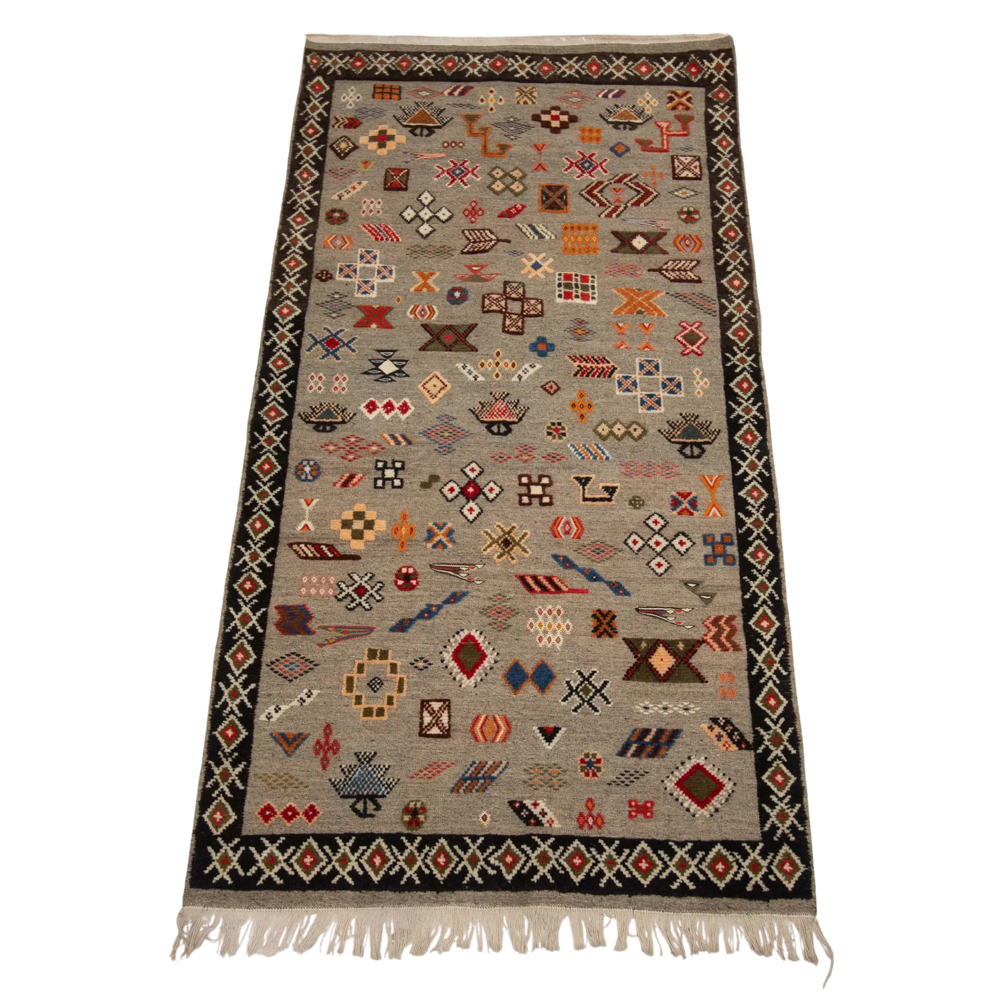 Full view of a handwoven Moroccan rug with a gray background